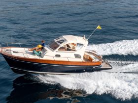 A couple enjoys a relaxing moment on a boat as it glides through the water, showcasing the perfect blend of leisure and adventure on the open sea.