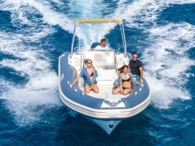 A lively group enjoys a thrilling ride on a speedboat, showcasing the excitement of on-water adventures under the sun.