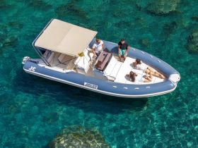 A lively group enjoys a day on a Joker boat, relaxing and sunbathing in crystal-clear waters — perfect for summer adventures and fun on the water.