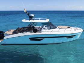 A sleek speedboat glides through crystal-clear waters, showcasing its modern design and vibrant colors — perfect for thrilling adventures on the sea.