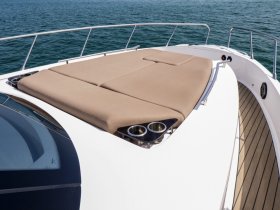 A cozy lounge area on a boat featuring plush seating, perfect for relaxing while enjoying the open water.
