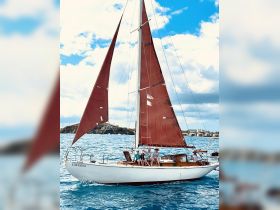 A group enjoys a sailing adventure aboard the 'Catalina,' showcasing the joy of being on the water with friends and family.