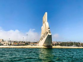 A stunning view of a prominent landmark by the harbor, showcasing the beautiful architecture against a clear blue sky — a perfect spot for sightseeing and photography.