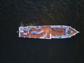 Aerial view of a spacious pontoon boat featuring comfortable seating and a stylish layout, perfect for relaxing on the water.