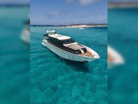 A stunning aerial view of a luxurious yacht anchored in crystal-clear waters, perfect for showcasing upscale boating experiences and island adventures.