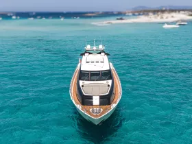 A stunning aerial view of a luxurious yacht anchored in crystal-clear turquoise waters, perfect for showcasing the beauty of boating adventures.