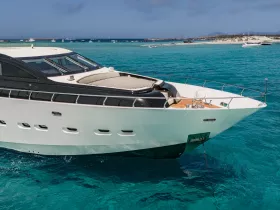 A stunning yacht glides through crystal-clear waters, showcasing its sleek design and luxurious features — perfect for upscale boating adventures.