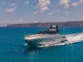 A stunning yacht glides through crystal-clear waters, showcasing its sleek design and elegance — perfect for luxury charters and ocean adventures.