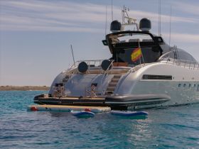 A stunning yacht anchored in clear turquoise waters, showcasing its sleek design and inviting deck space, perfect for luxury getaways.