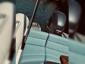 A close-up view of comfortable seating inside a boat, showcasing the stylish design and inviting atmosphere for relaxation on the water.