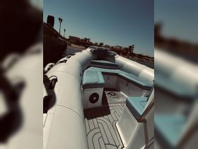Interior view of a sleek boat featuring comfortable seating and a modern helm, perfect for enjoying a day on the water.