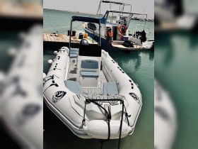 A sleek speedboat docked at the marina, showcasing its modern design and comfortable seating — perfect for thrilling water adventures.