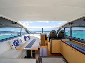 The stylish interior of a luxury yacht features comfortable seating and a modern helm, perfect for enjoying the open waters in comfort.