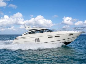 A sleek yacht cruising through clear waters, showcasing its elegant design and powerful performance — perfect for luxury outings on the sea.