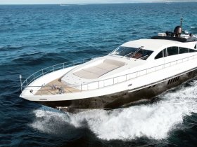 A stunning yacht cuts through the waves, showcasing its sleek design and elegance while underway in open waters.