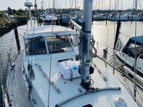 A detailed view of a boat docked in a marina, showcasing its structure and surroundings — perfect for boat enthusiasts and potential charters.
