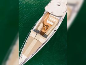 An aerial view of the luxurious interior of a boat, showcasing spacious seating and elegant design — perfect for relaxing on the water.