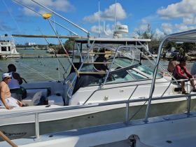 A lively group enjoys their time aboard a fishing boat, showcasing the fun and camaraderie of a day on the water.