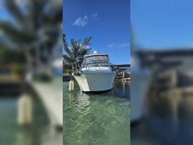 A clear view of a boat docked in calm waters, showcasing its sleek design against a bright blue sky — perfect for boating enthusiasts and charters.