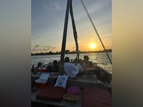A couple enjoys a romantic sunset on a boat, creating a perfect backdrop for memorable celebrations in the water.