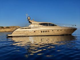 A stunning side view of a luxurious yacht docked in calm waters, showcasing its elegant design against a clear blue sky.
