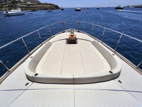A spacious lounge area on the deck of a luxury yacht, perfect for relaxing and enjoying the scenic views of the open water.