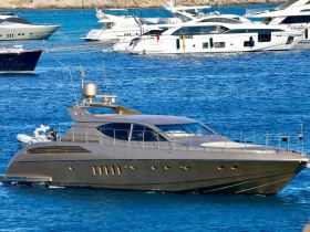 A sleek yacht glides through clear blue waters, showcasing its elegant design and luxurious features — perfect for upscale boating experiences.