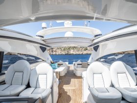 A sleek interior view of a luxury yacht's helm area, featuring comfortable seating and a stylish design, perfect for navigating the open waters.