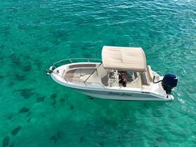 Aerial view of the 'Summer Dream' speedboat gliding through crystal-clear turquoise waters, showcasing the perfect vessel for a day of adventure on the sea.