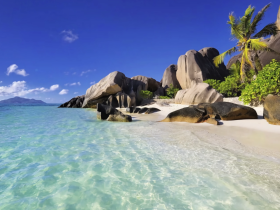 A stunning view of a tropical beach featuring crystal-clear waters and unique rock formations, perfect for showcasing the natural beauty of coastal destinations.