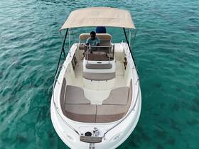 Aerial view of the interior of a boat featuring comfortable seating and a helm, perfect for a day on the water.