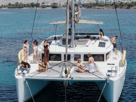 A lively group enjoys a sun-soaked day aboard a catamaran, capturing the essence of summer fun with friends on the water.