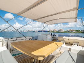 A spacious interior view of a yacht's helm and seating area, showcasing a stylish design and inviting atmosphere for comfortable cruising.