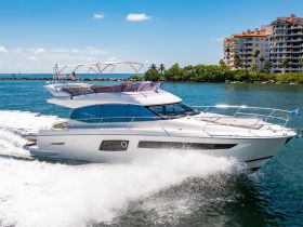 A stunning yacht, the Prestige 500, glides through the water, showcasing its sleek design and elegance — perfect for luxury cruising.