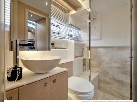A modern and stylish bathroom interior of a Jeanneau DB 43, featuring elegant fixtures and ample storage, perfect for onboard comfort.