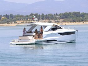 A lively group enjoys a sunny day aboard a luxurious yacht, perfect for summer outings and relaxation on the water.