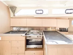 A well-designed boat kitchen featuring modern appliances and ample storage, perfect for preparing meals while at sea.