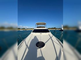 A stunning view of a yacht's bow against a clear blue sky, showcasing its sleek design and inviting atmosphere for a day on the water.