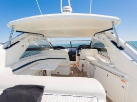 A bright and spacious interior view of a boat's helm and seating area, showcasing modern design and comfort for a relaxing day on the water.