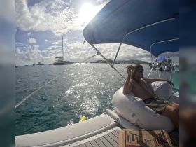 A relaxed individual enjoys the sun on a boat, showcasing the perfect atmosphere for a day on the water.