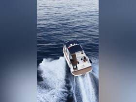 A couple enjoys a thrilling ride on a stylish yacht named 'Bella,' cutting through the serene waters — perfect for romantic getaways or adventurous outings.