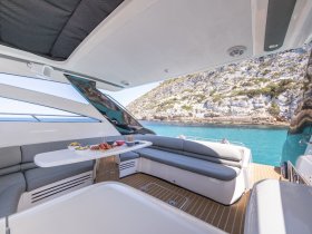A beautifully arranged spread of snacks on a sleek boat interior, perfect for enjoying while cruising through stunning coastal waters.