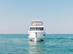 A stunning view of a yacht cruising through clear waters, showcasing its elegant design and perfect for luxury boating experiences.