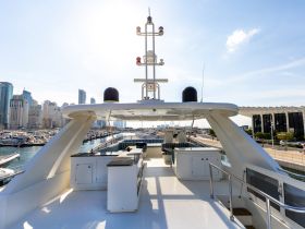 A spacious helm area on a luxury yacht, featuring comfortable seating and a sleek design, perfect for enjoying the views while cruising.