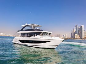 A stunning yacht cruising through clear waters with a vibrant city skyline in the background, perfect for luxury charters and scenic tours.