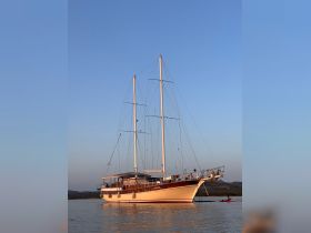 A stunning sailboat anchored in calm waters under a clear sky, showcasing its elegant design and perfect for serene sailing adventures.
