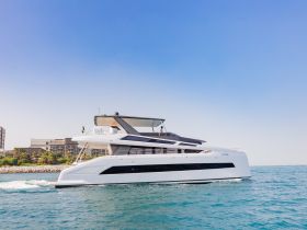 A sleek yacht glides through the water, showcasing its modern design and elegance — perfect for luxury charters and coastal adventures.