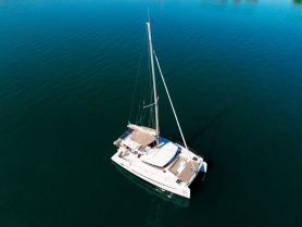 Aerial view of a sleek catamaran gliding through calm waters, showcasing its elegant design and perfect for serene sailing adventures.