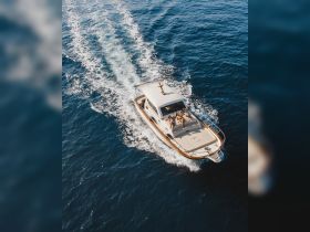 A lively group enjoys a day on a yacht cruising through sparkling blue waters, perfect for summer adventures and relaxation on the sea.