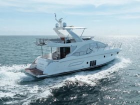 A stunning aerial view of a luxurious yacht cruising through sparkling waters, perfect for upscale charters and leisure outings.